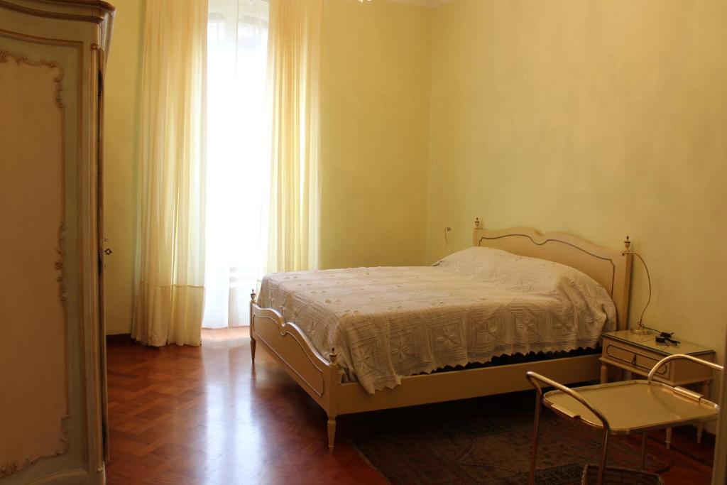 a bedroom with a bed and a window and a chair at Croisette in Turin