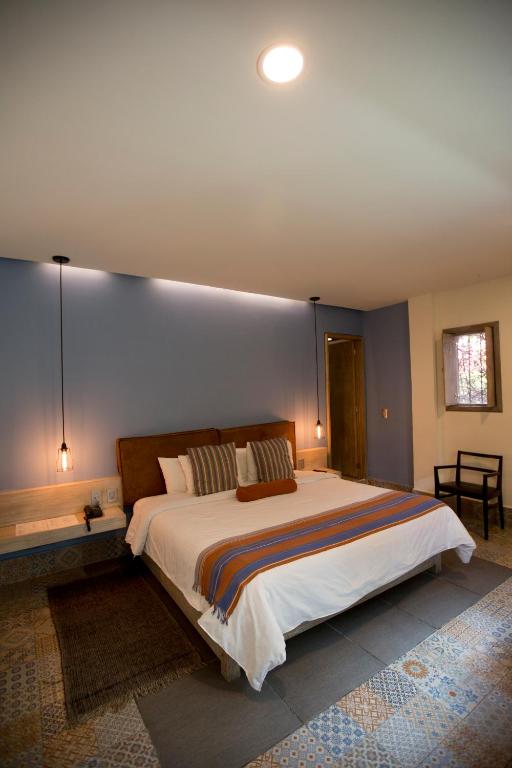 Postel nebo postele na pokoji v ubytování Hotel Helverica