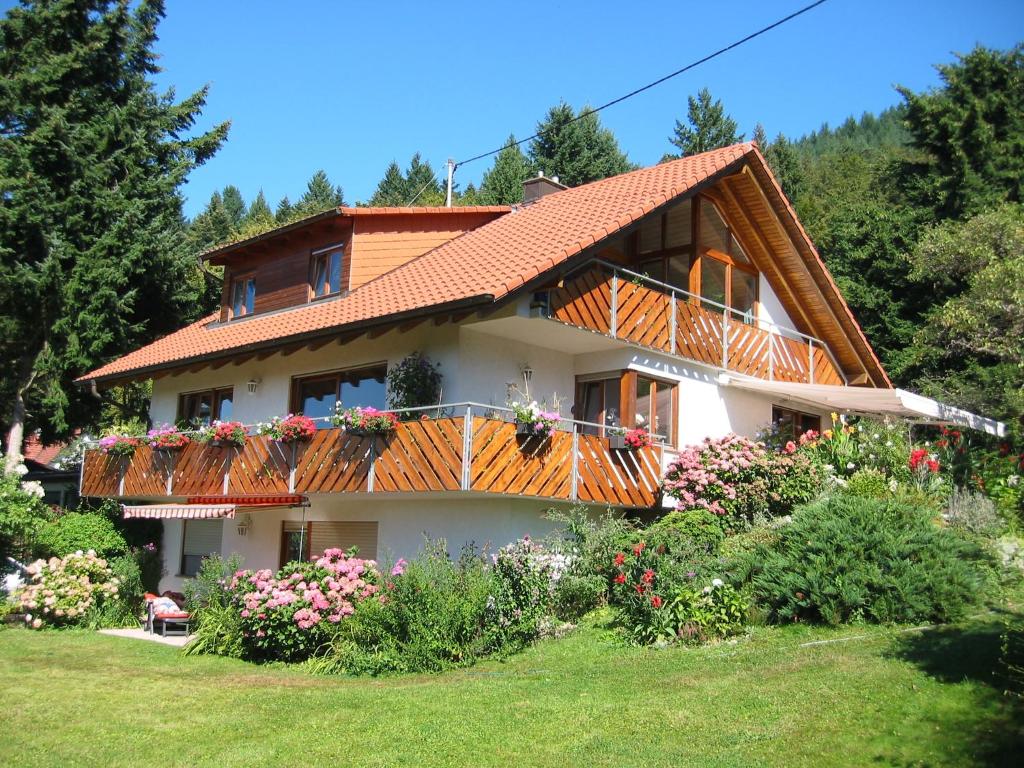 a house with a balcony with flowers on it at Haus Fernblick in Badenweiler