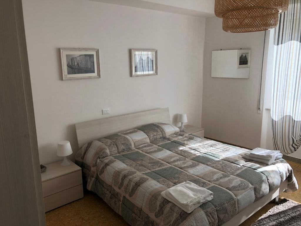 - une chambre avec un lit, deux lampes et une fenêtre dans l'établissement Miky Home, à La Spezia