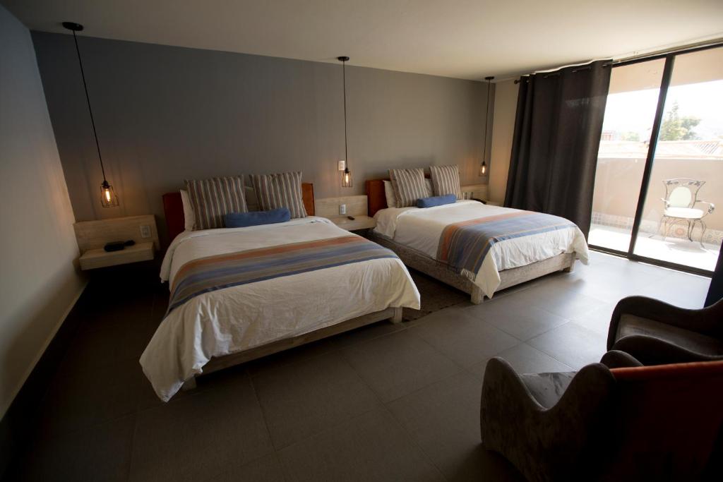 Postel nebo postele na pokoji v ubytování Hotel Helverica