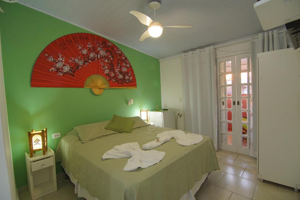 Cama ou camas em um quarto em Pousada Irashai