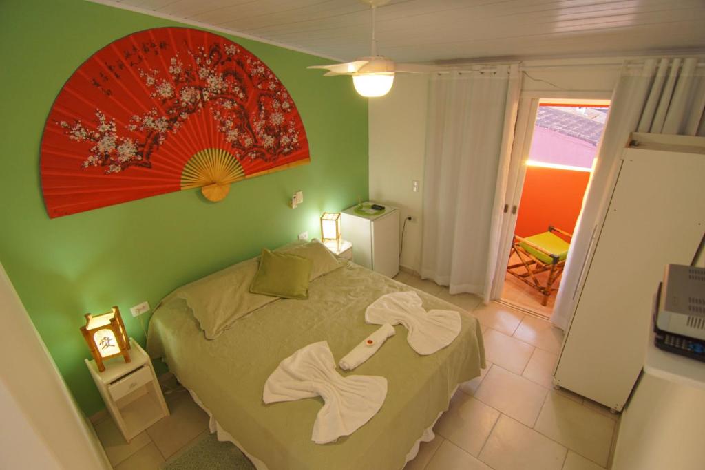 Cama ou camas em um quarto em Pousada Irashai