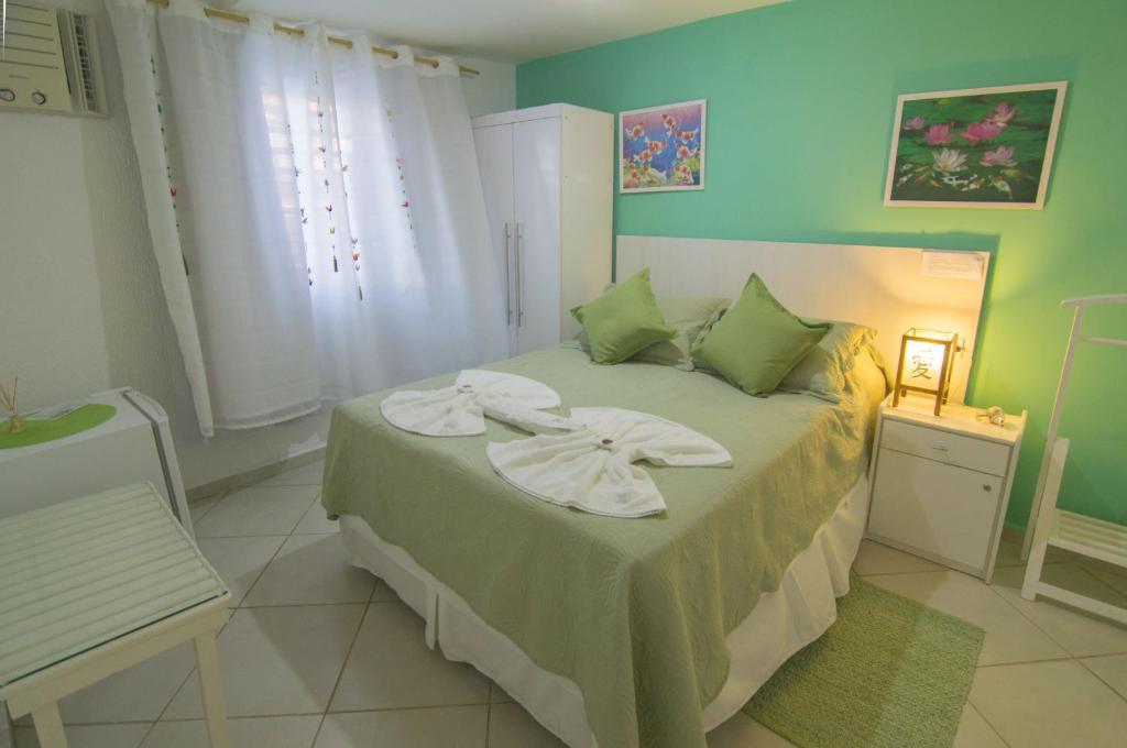 Cama ou camas em um quarto em Pousada Irashai