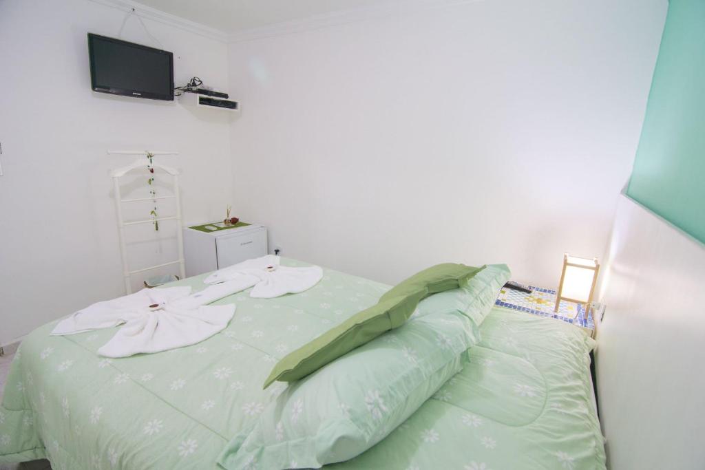 Cama ou camas em um quarto em Pousada Irashai