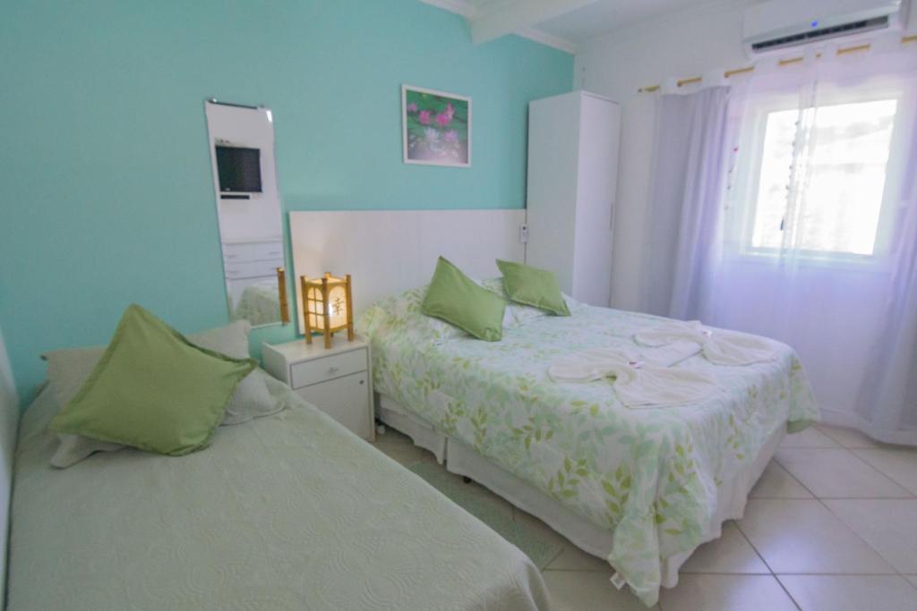Cama ou camas em um quarto em Pousada Irashai