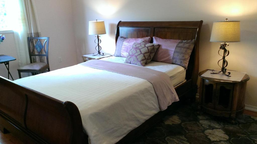 a bedroom with a large bed with two tables and two lamps at HB Guest Home 5 in Waterloo
