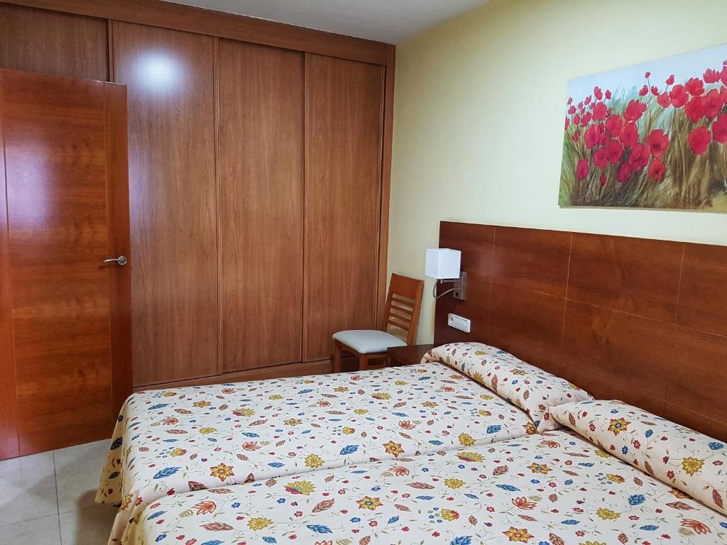 Postel nebo postele na pokoji v ubytování Apartamentos Doña Lucía
