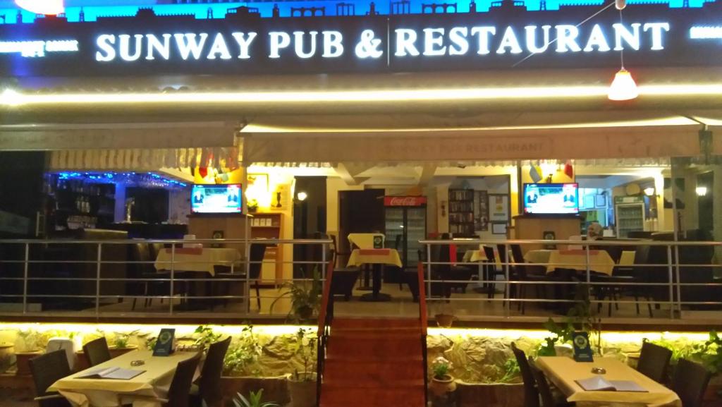 a restaurant with tables and chairs in front of it at Sunway Hotel in Alanya