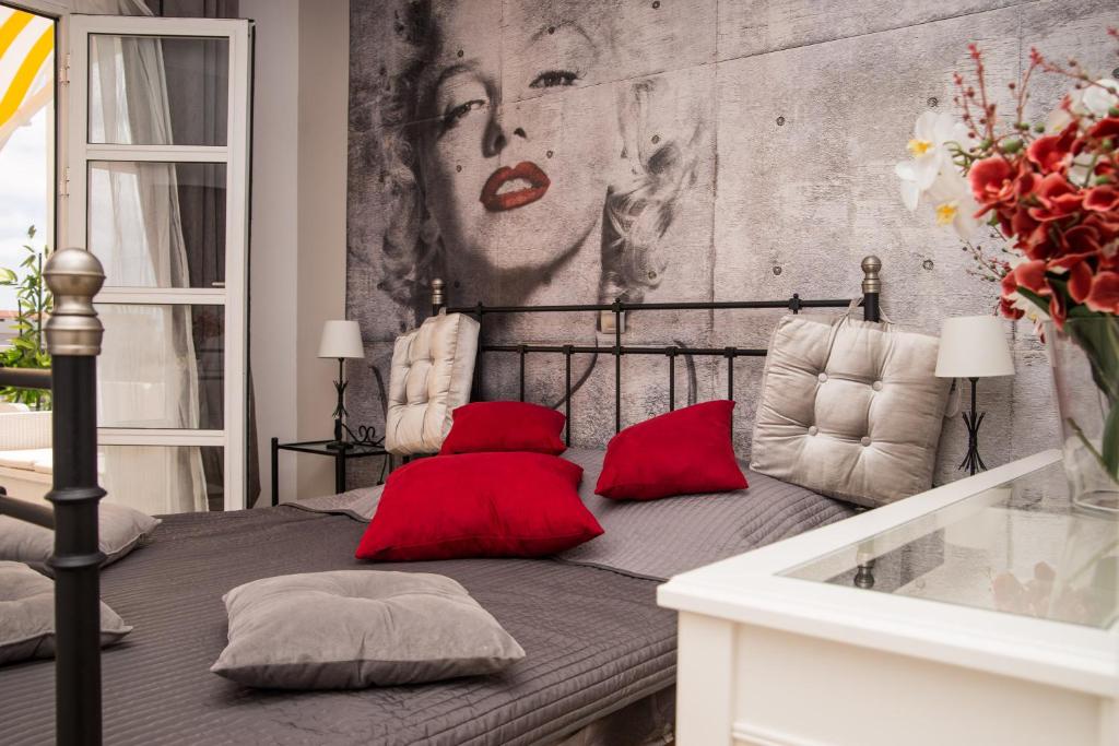 a bedroom with a bed with red pillows on it at Fantastic Apartment Marilyn Orlando 85 in Adeje