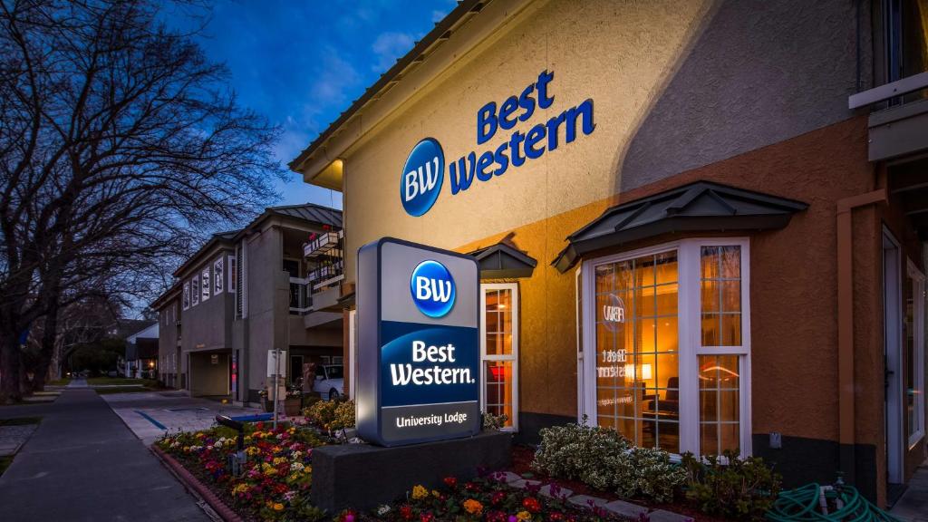 a best western sign in front of a store at Best Western University Lodge in Davis