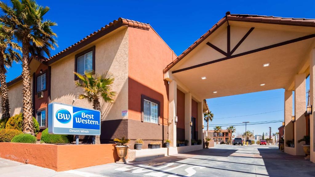 a best western sign in front of a building at Best Western Desert Winds in Mojave