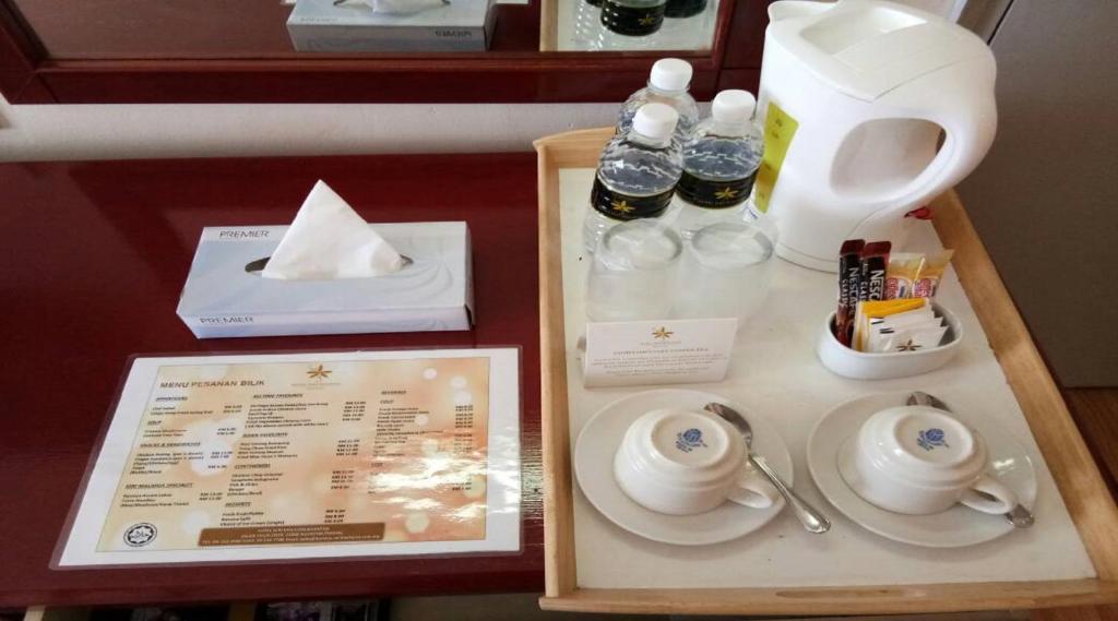 a table with a tray with a tea set on it at Hotel Seri Malaysia Kuantan in Kuantan