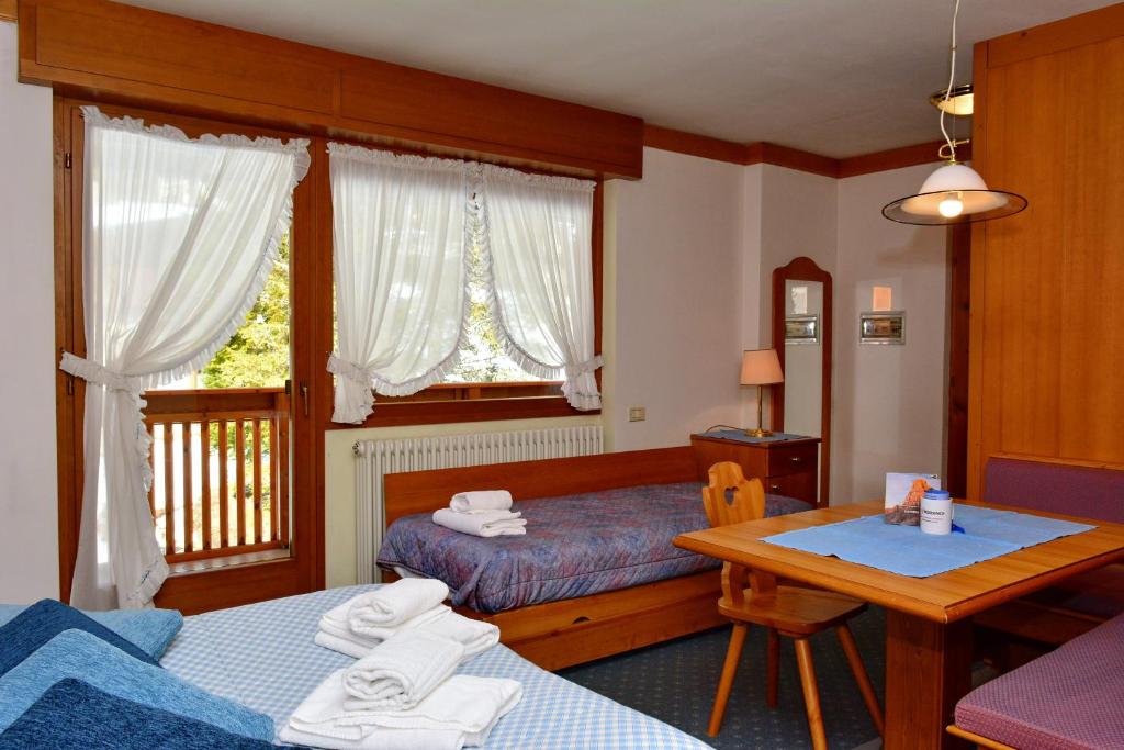 Posteľ alebo postele v izbe v ubytovaní Ski Residence