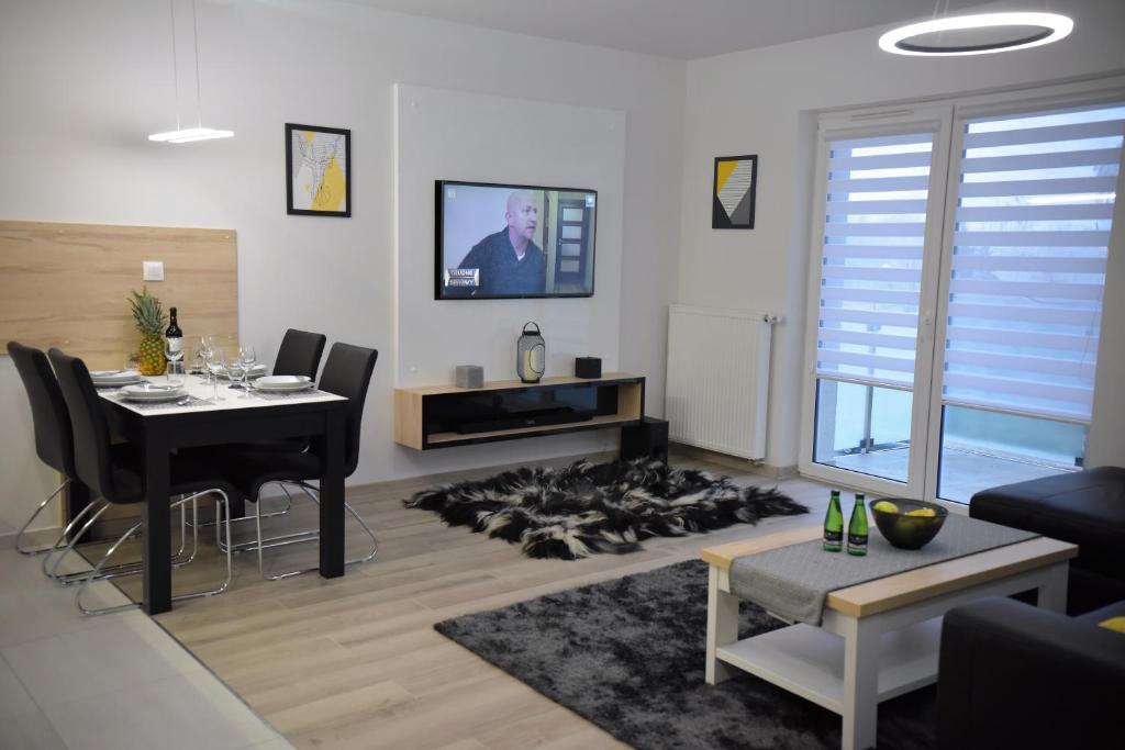 a living room with a table and a dining room at Apartamenty Platan Opieszyn 2 in Września