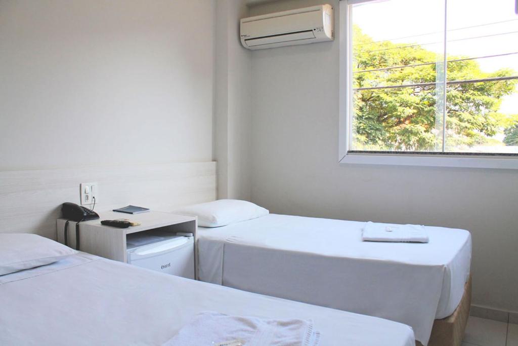Postel nebo postele na pokoji v ubytování MFG Hotel