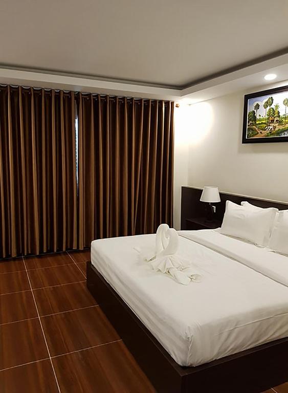 Postel nebo postele na pokoji v ubytování Apple Hotel Two - Near Phnom Penh Airport