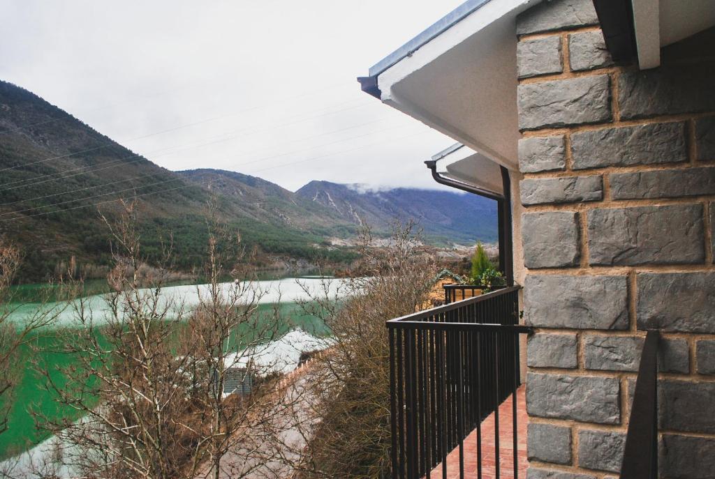 a balcony with a view of a river and mountains at El Capricho de Arguis in Arguis