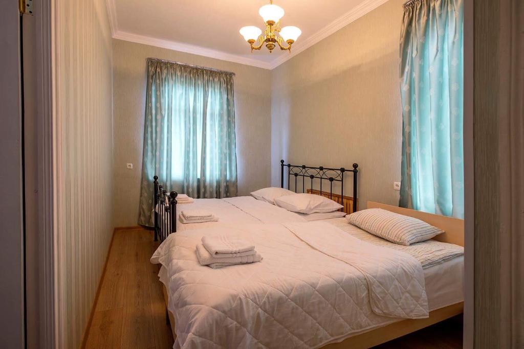 a bedroom with two twin beds with towels on them at Gogi Dvalishvili Wine Cellar in Gori