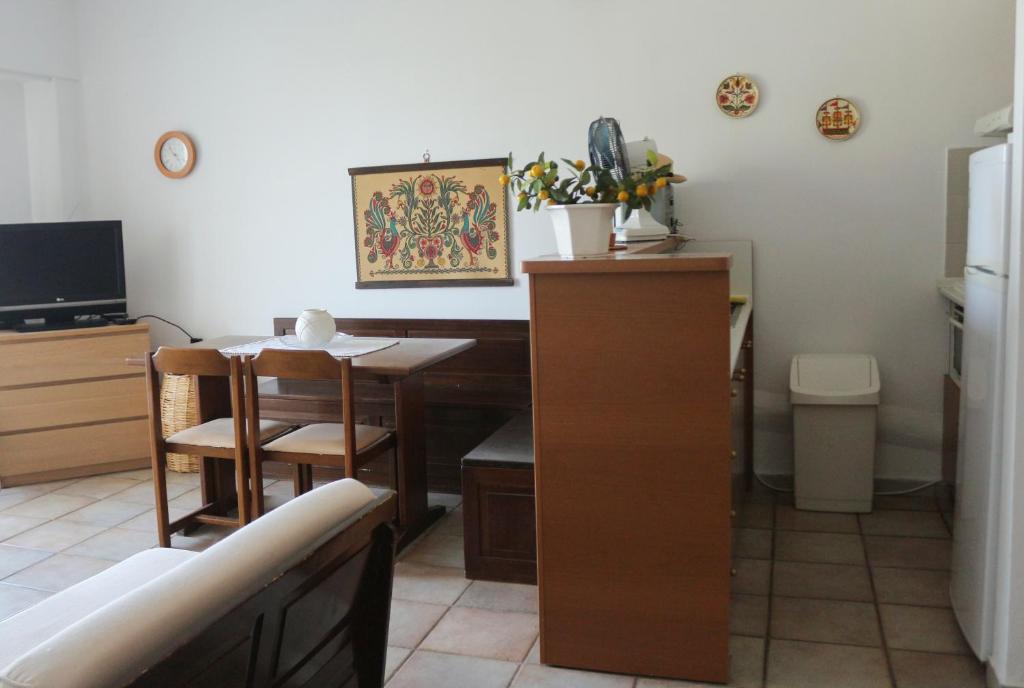 a kitchen with a desk and a table with a chair at Holiday Home by the Sea in Nea Potidaea