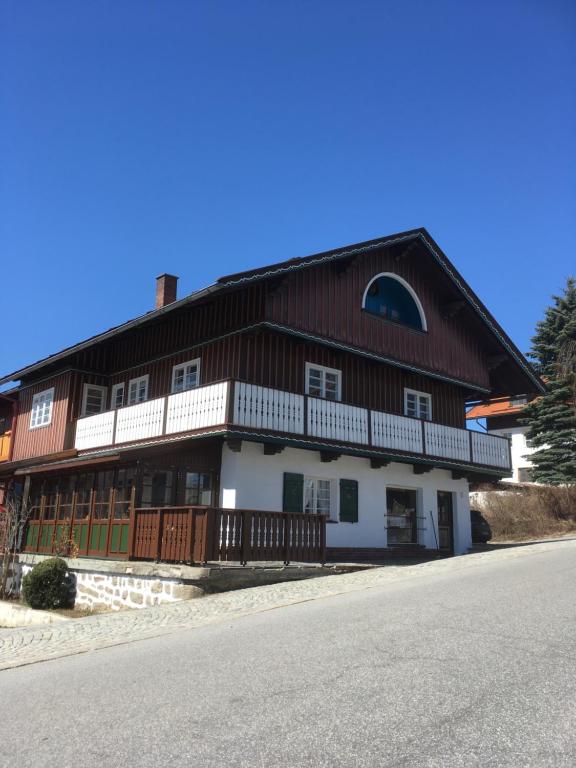 a large wooden building with a gambrel roof at Haus Poxleitner in Mauth