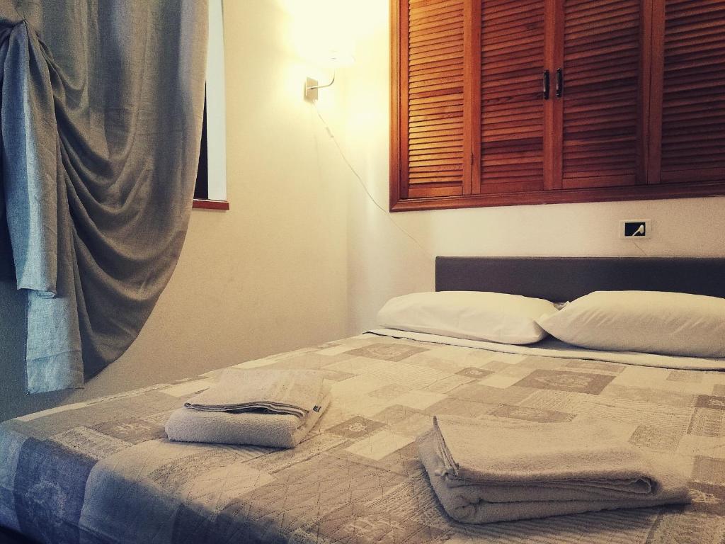a bedroom with a bed with two towels on it at Vintage Apartment in Vernazza