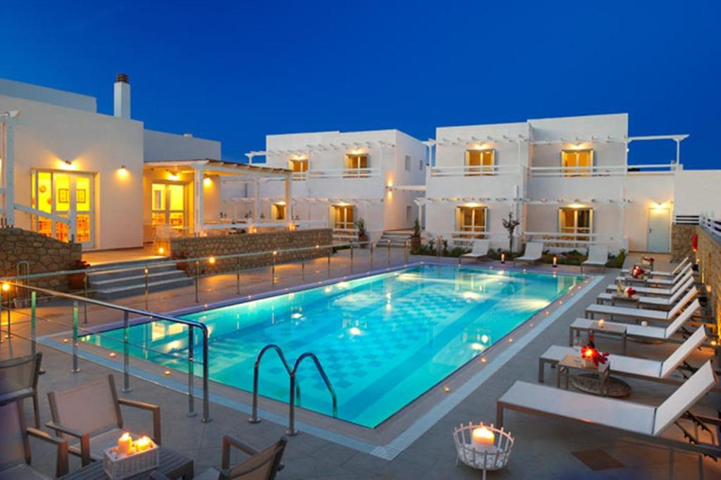 a swimming pool in front of a villa at night at Perigiali in Skiros