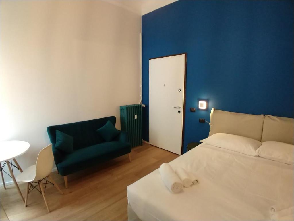 ein Schlafzimmer mit einem weißen Bett und einer blauen Wand in der Unterkunft Blue Design Suite in Mailand