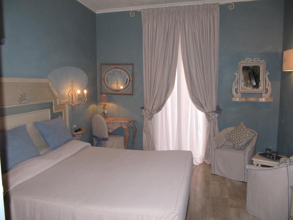 Postel nebo postele na pokoji v ubytování Hotel La Colonnina