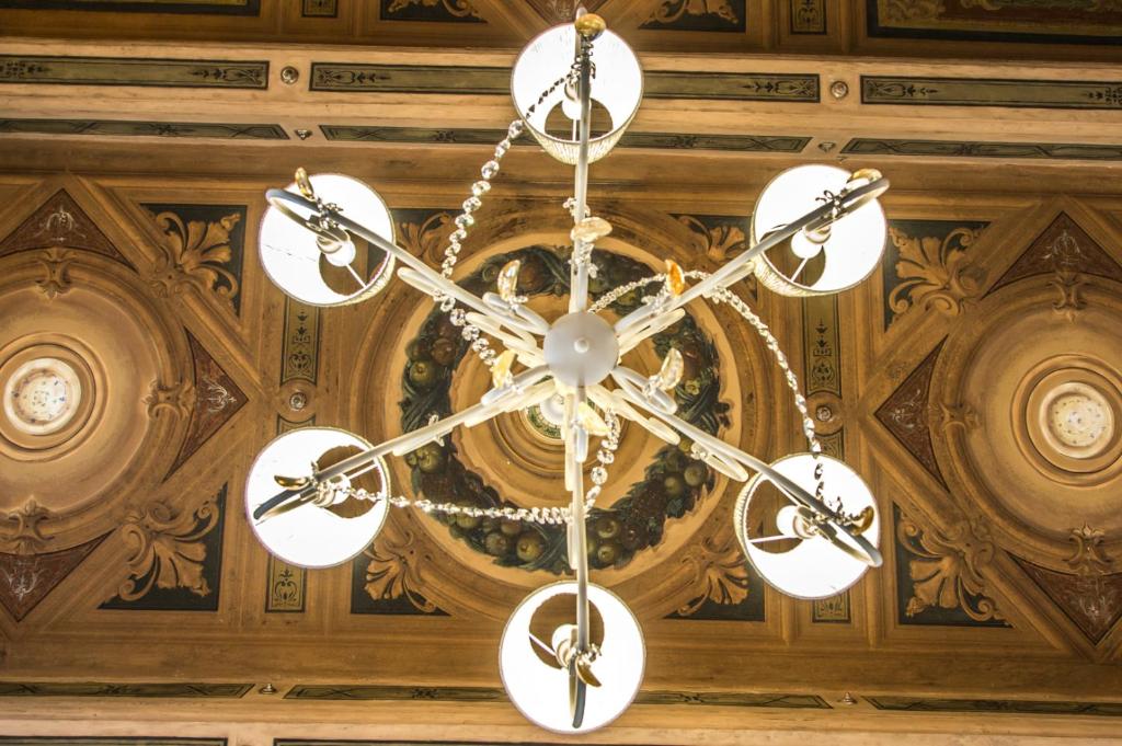 a chandelier hanging from a ceiling in a room at Rinascimento Bed & Breakfast in Pisa