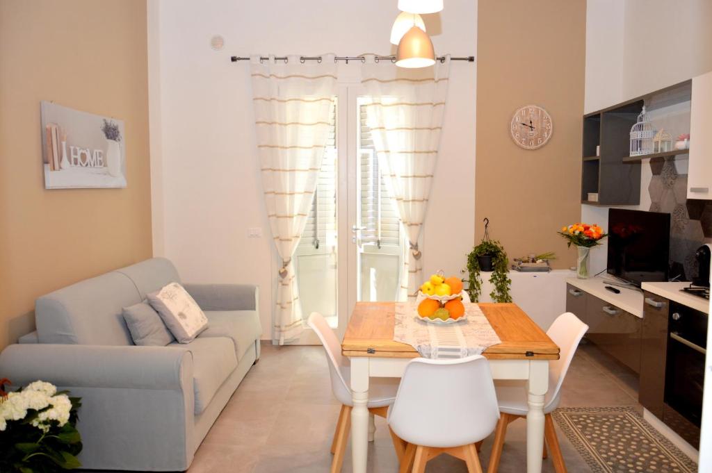 a living room with a table and a couch at Lorelai Inn in Marsala