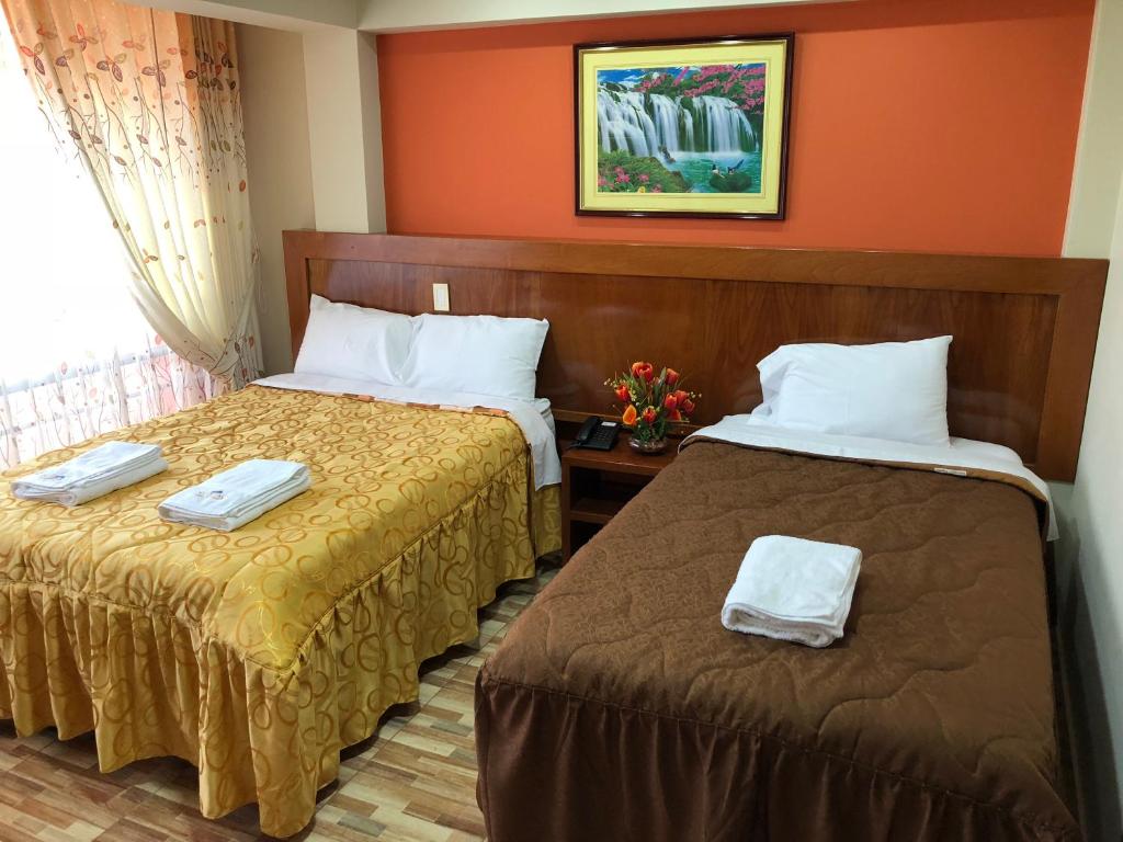 Postel nebo postele na pokoji v ubytování Sumaq Hotel Tacna