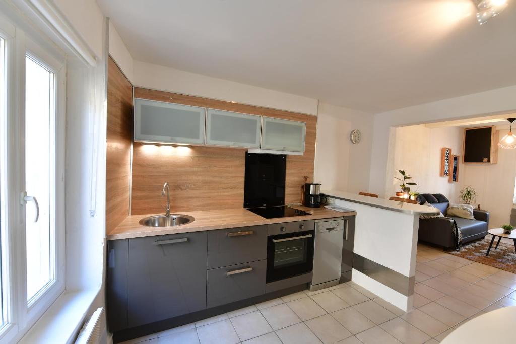 a kitchen with a sink and a counter top at Maison de village Sud de France in Marsillargues