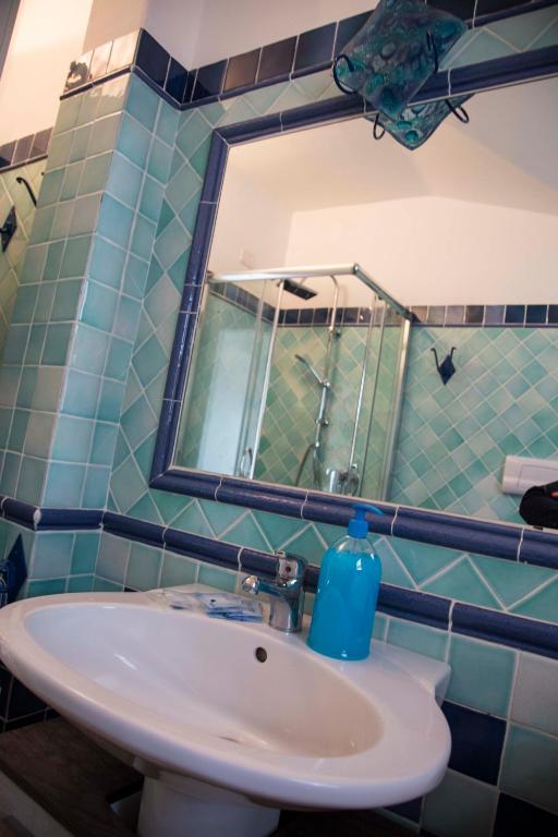 a bathroom with a sink and a mirror at Bados Mare in Olbia
