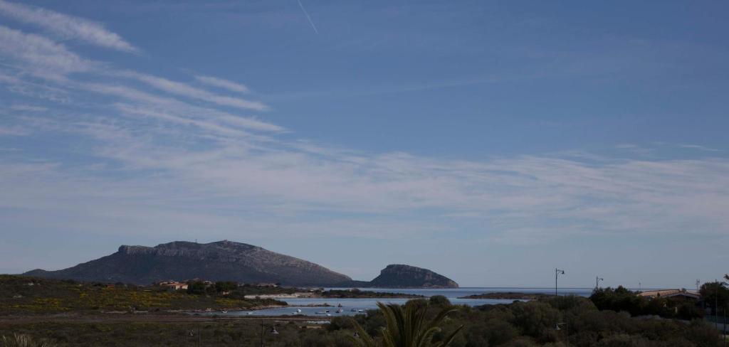 a view of the ocean with mountains in the background at Bados Mare in Olbia