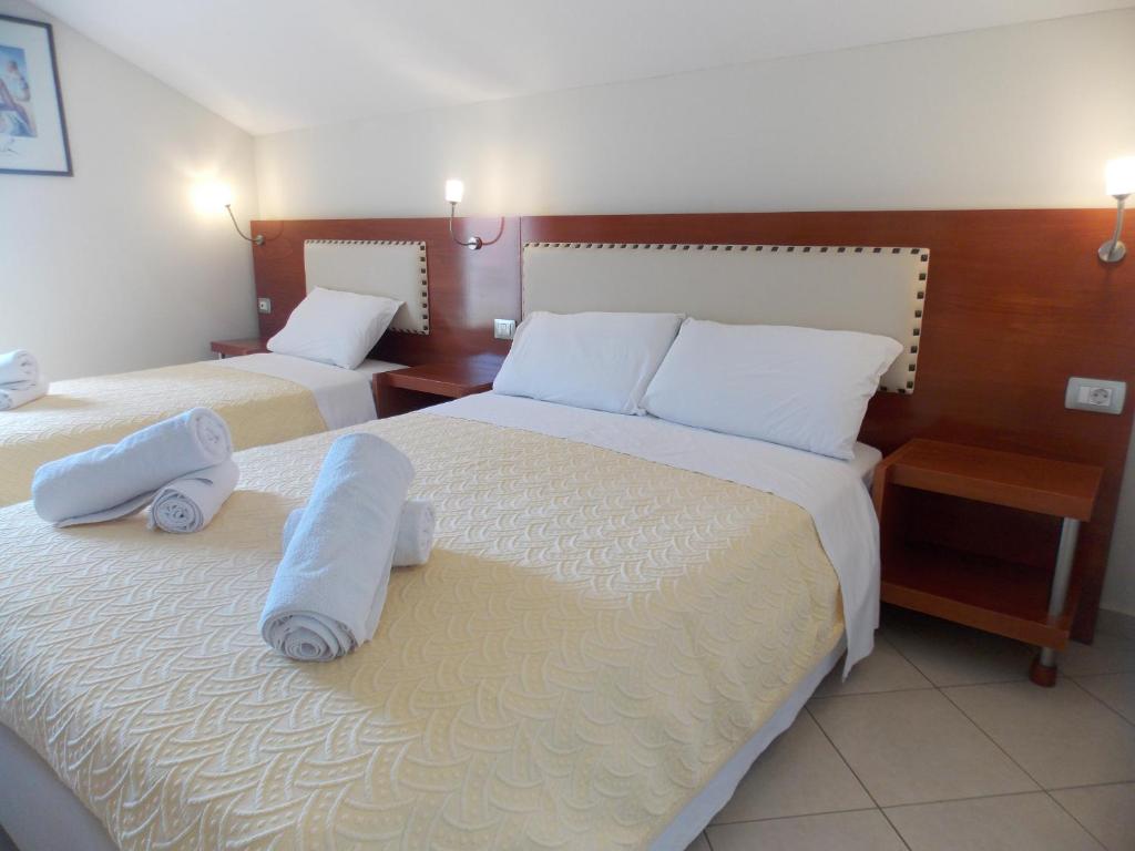 Postel nebo postele na pokoji v ubytování Hotel Veli