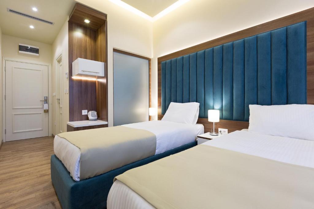 Postel nebo postele na pokoji v ubytování Marquise Hotel Garni
