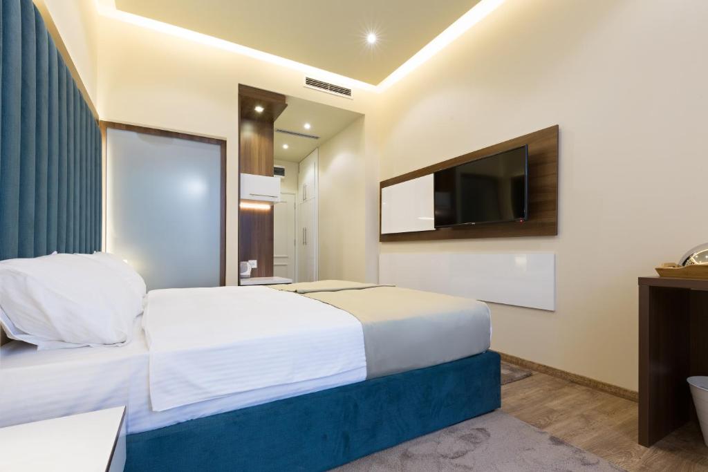 Postel nebo postele na pokoji v ubytování Marquise Hotel Garni