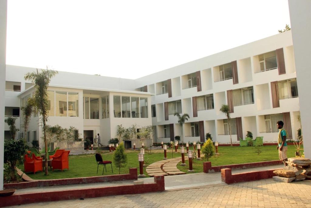 a man standing in front of a building at Saaral Resort By Crossway in Kuttālam