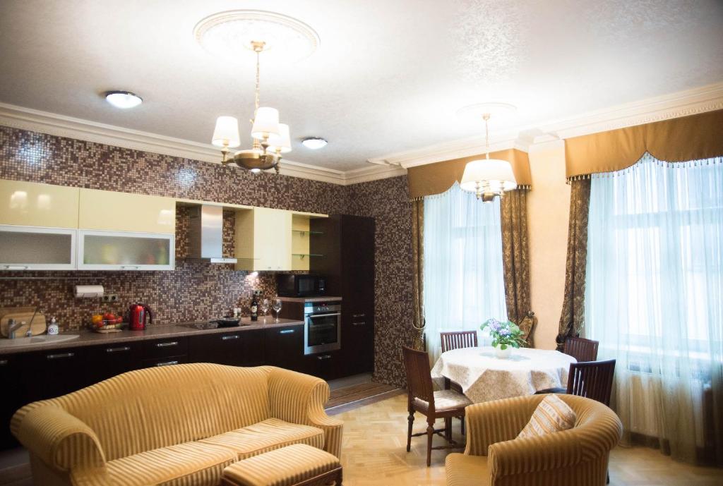 a kitchen and dining room with a table and chairs at Riga Center Old Town Apartment in Rīga