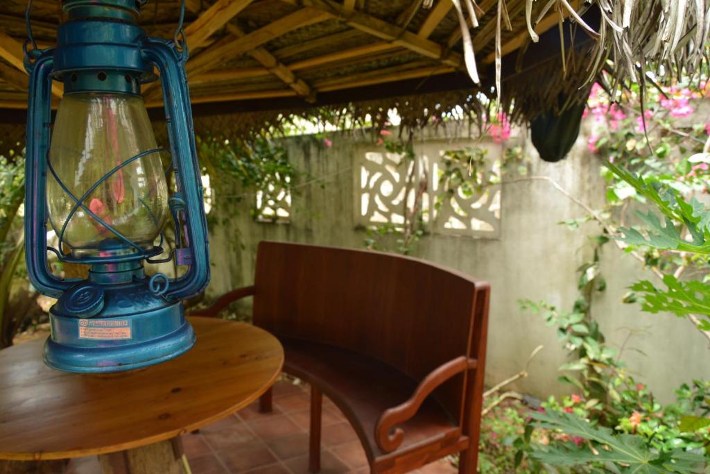 a blue lantern sitting on a wooden table with a chair at Sampathaa Residence in Negombo