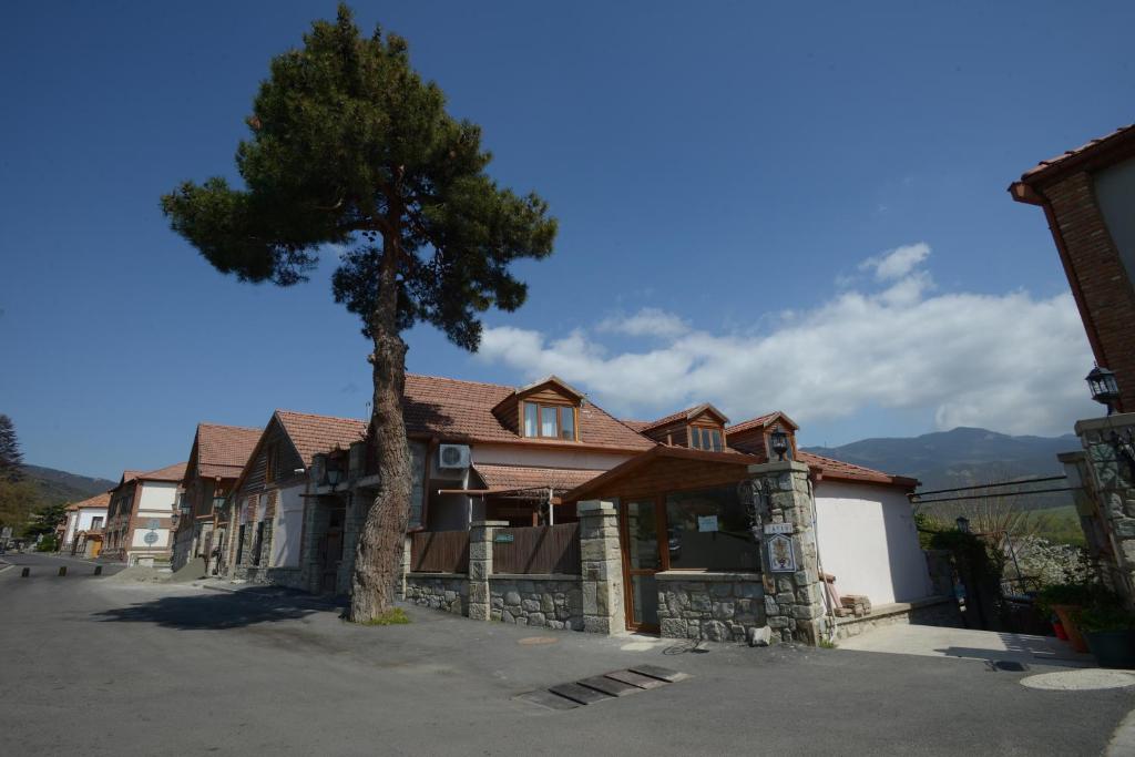 a house with a tree in front of it at Hotel Cité in Mtskheta