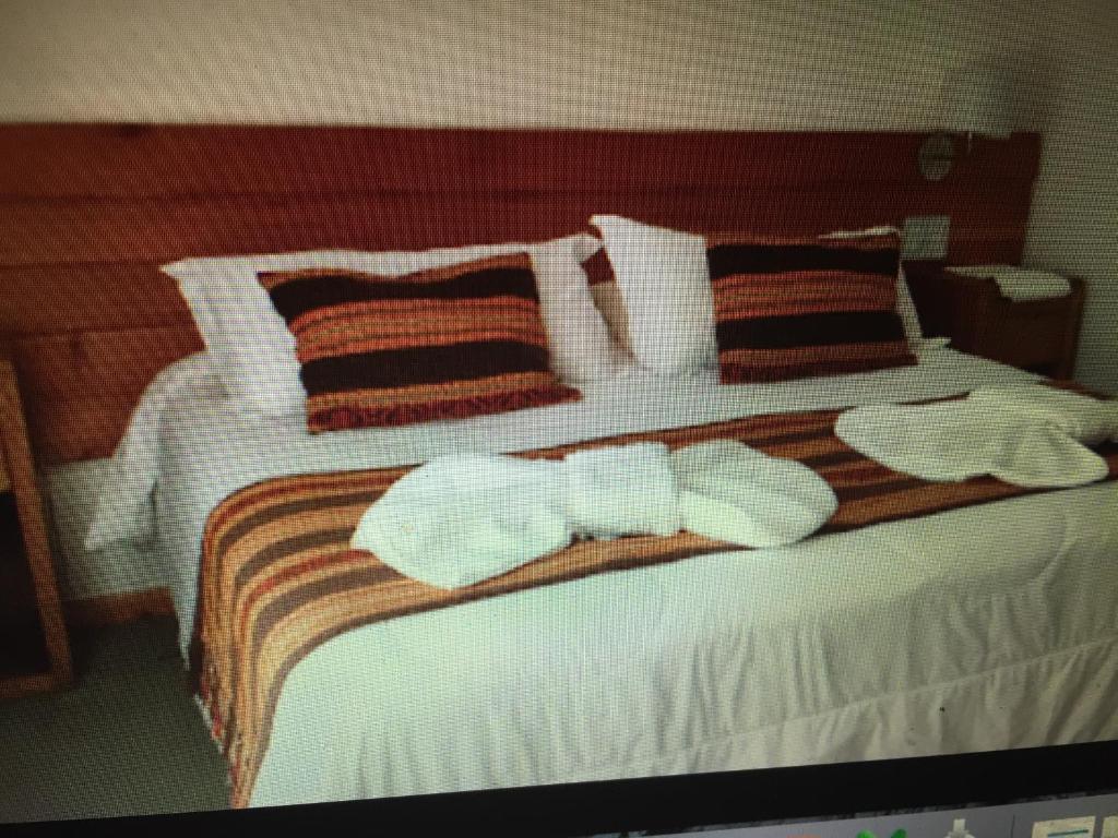 Ένα ή περισσότερα κρεβάτια σε δωμάτιο στο San Carlos de Bariloche Departamento en Cerro Catedral