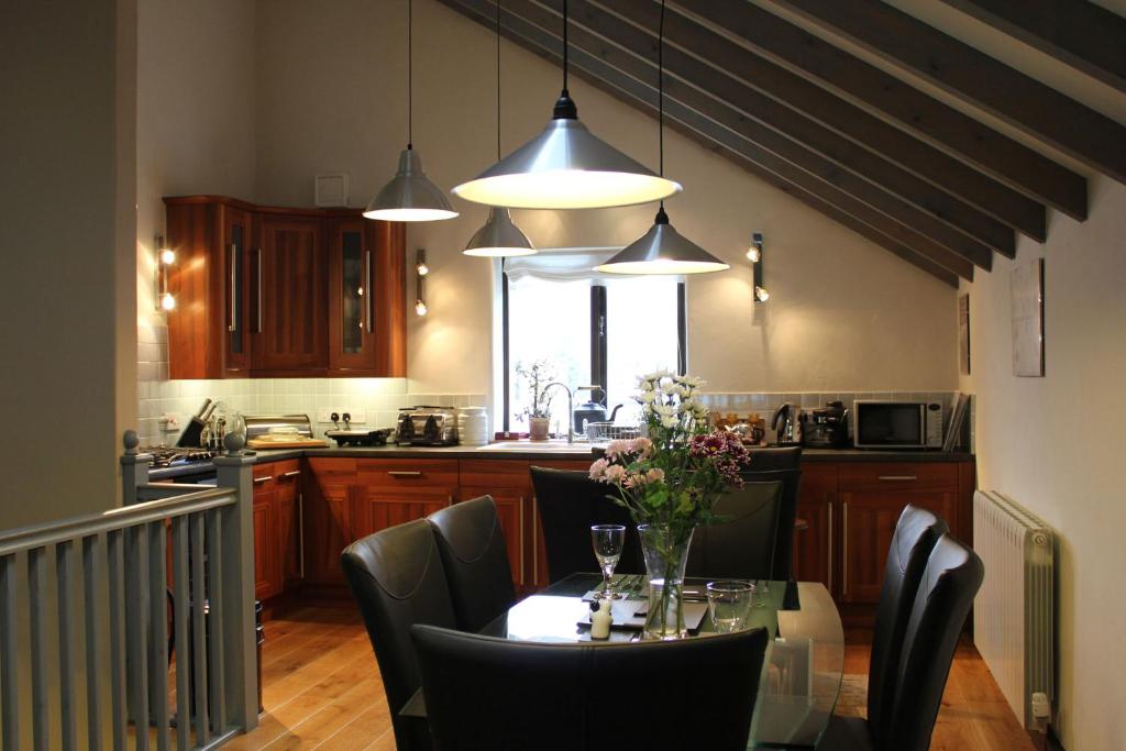 a kitchen with a table with chairs and a dining room at Alston Art Apartments in Alston