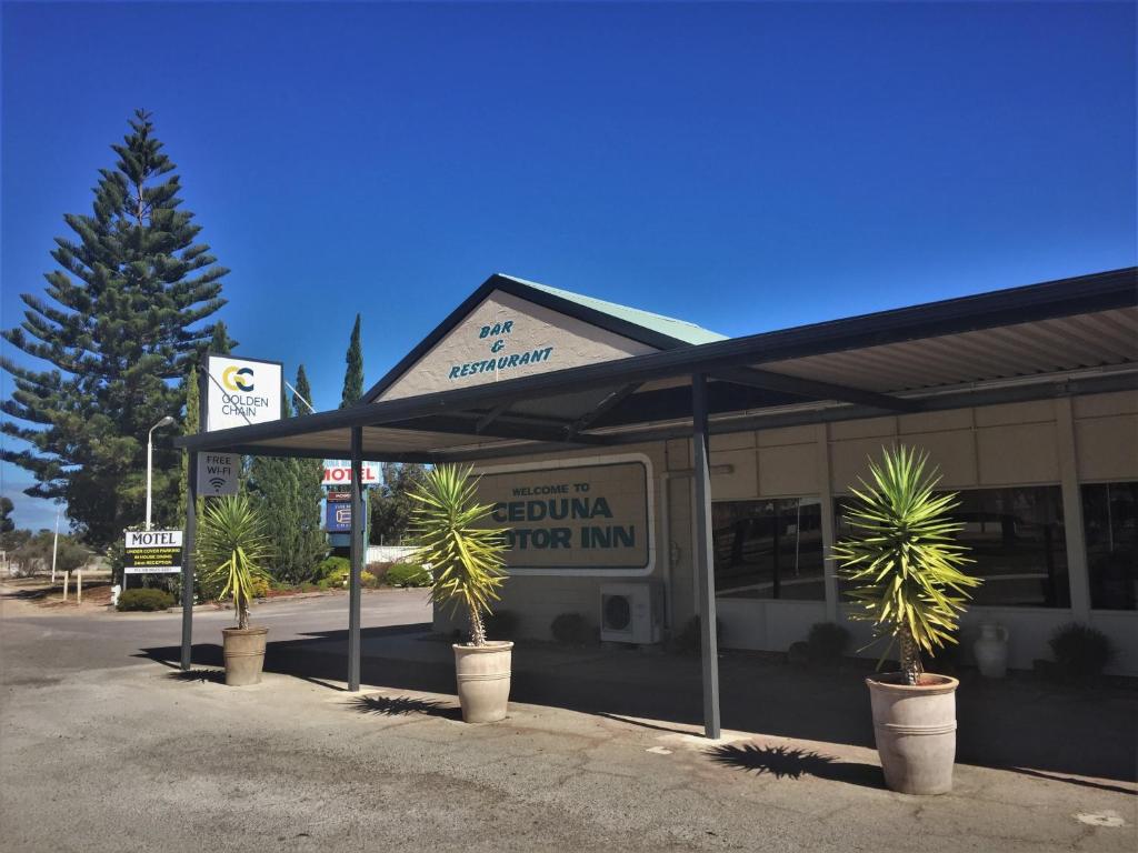 a gas station with palm trees in front of it at Ceduna Motor Inn in Ceduna