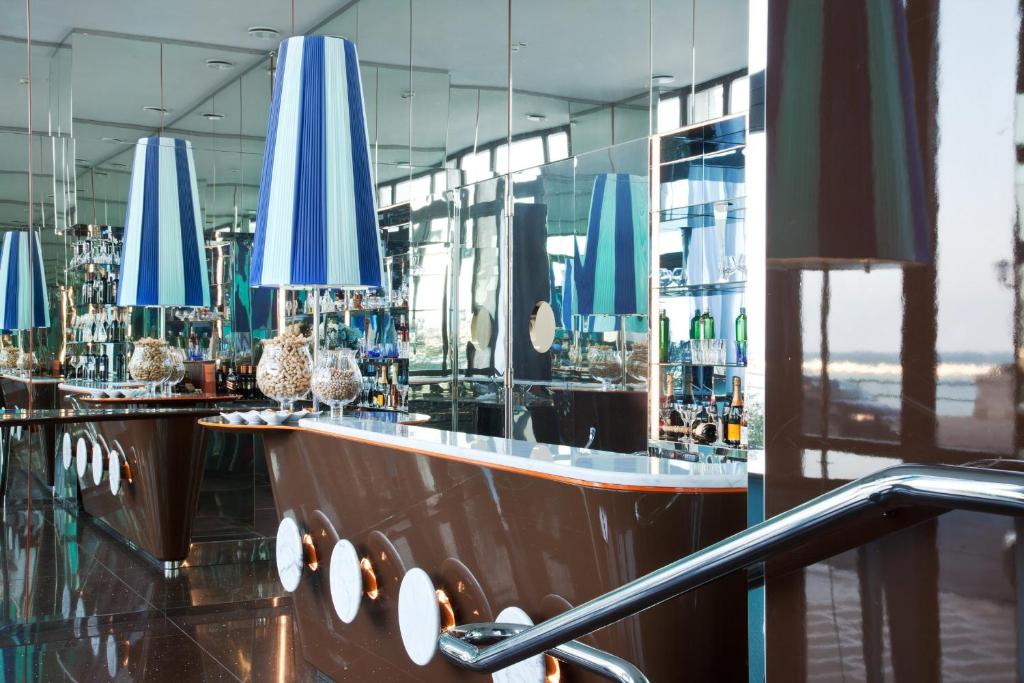 a bar with blue umbrellas on top of it at JR Hotels Bari Grande Albergo delle Nazioni in Bari