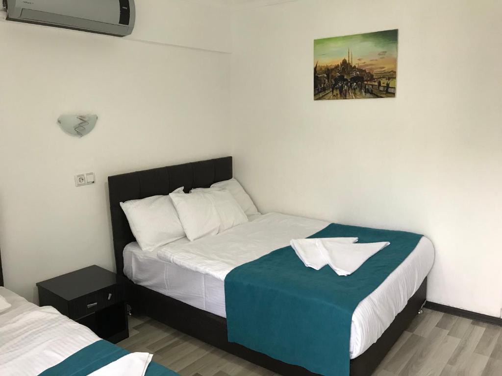 Postel nebo postele na pokoji v ubytování Sunrise Aya Hotel