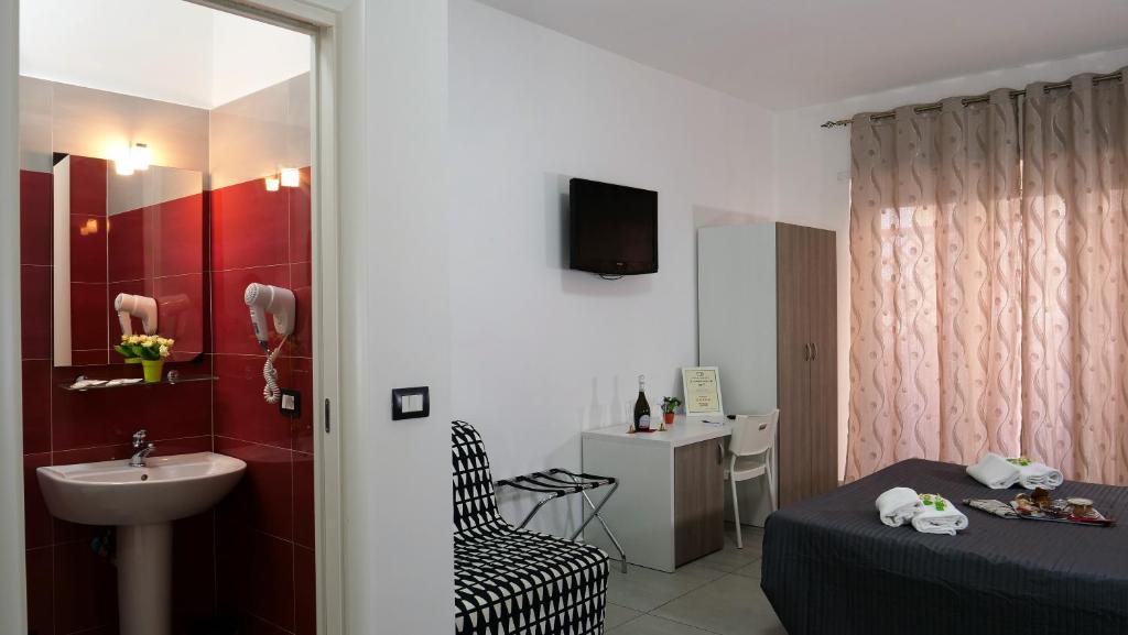 łazienka z łóżkiem, umywalką i umywalką w obiekcie Tiburtina Royal Suites w Rzymie