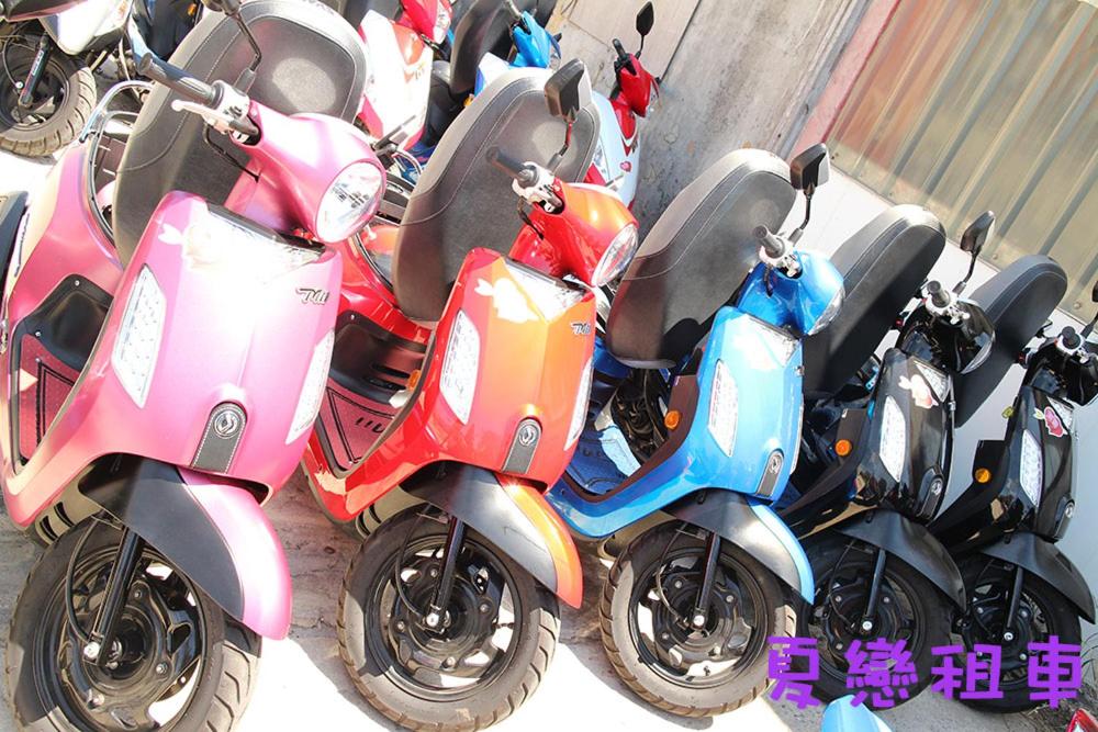 a row of scooters parked next to each other at Dreamily Fish B&amp;B in Magong