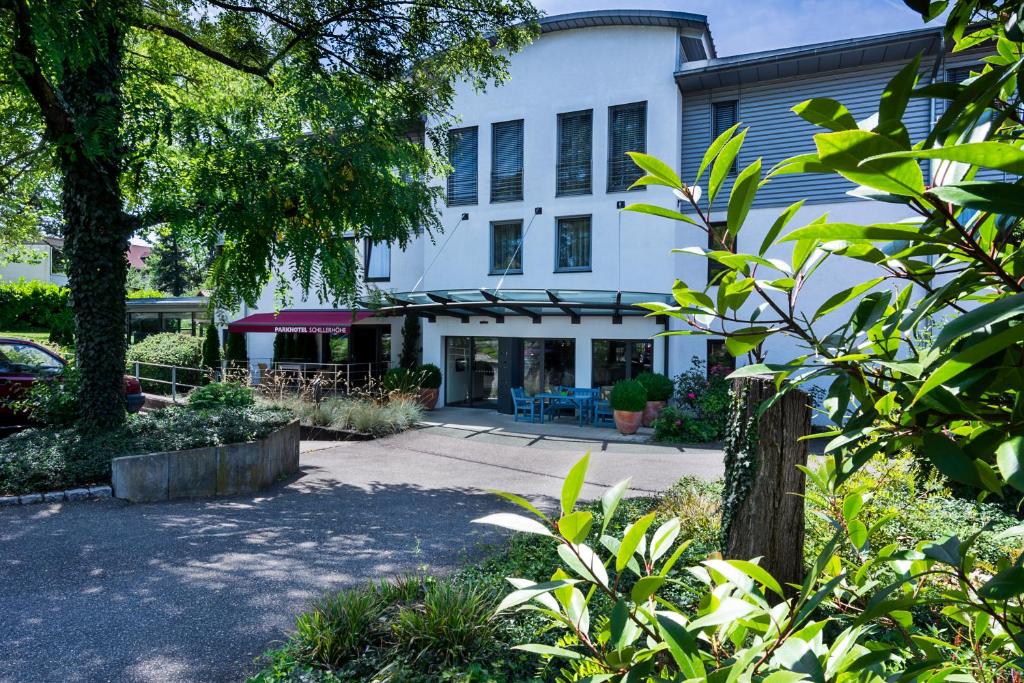 a white building with a patio in front of it at Parkhotel Schillerhöhe in Marbach am Neckar